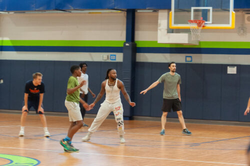 Staff vs students basketball game in action